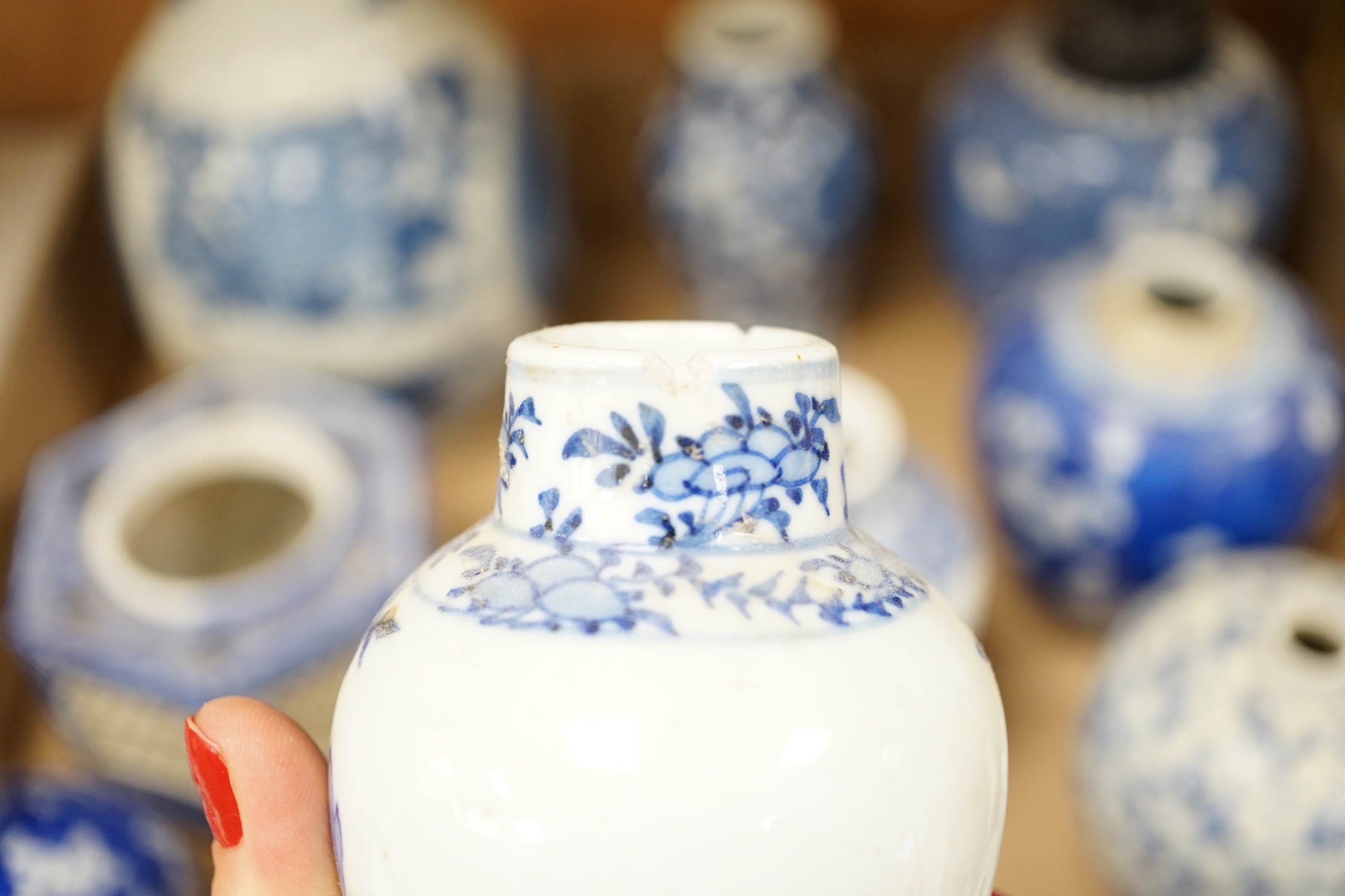 A collection of 18th - early 20th century Chinese blue and white porcelain vases, jars and spare covers, together with some Japanese blue and white ceramics, tallest 21cm